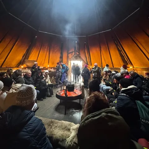 A fire burning inside a Sami lavvu